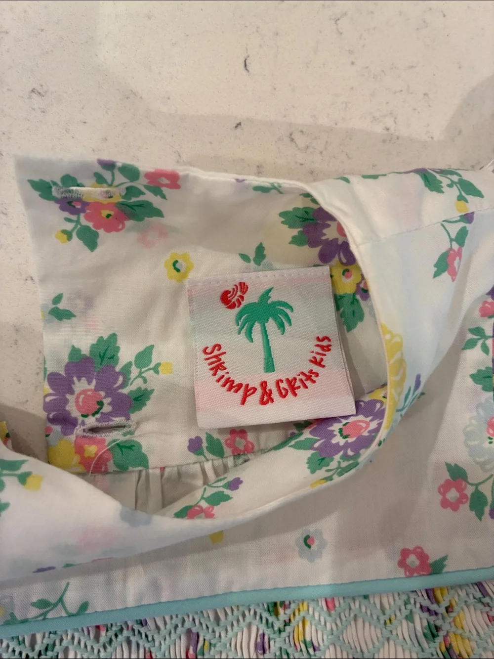 Floral Smocked Baby Romper - White with Yellow, Purple & Green Flowers